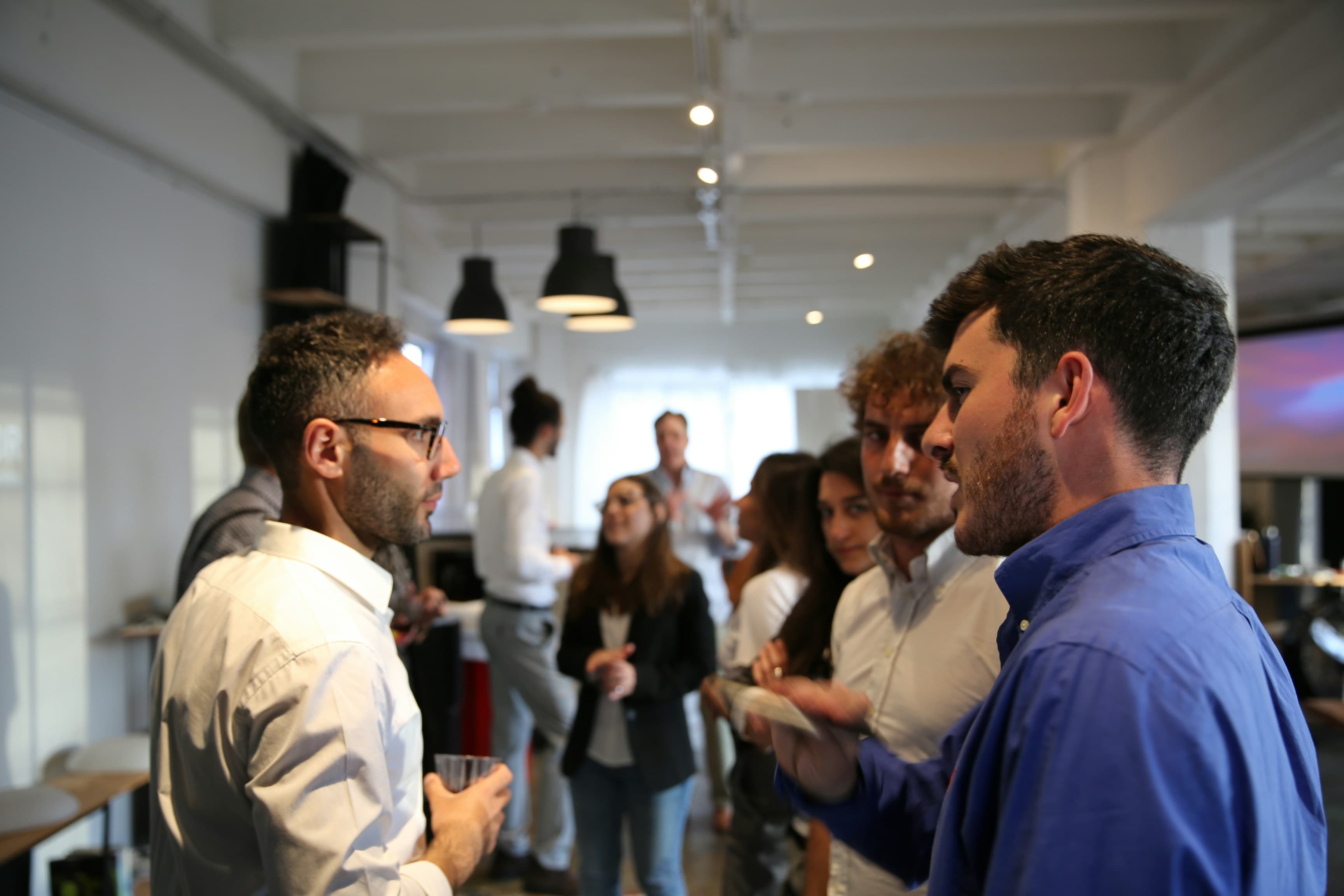People in conversation at an indoor community gathering